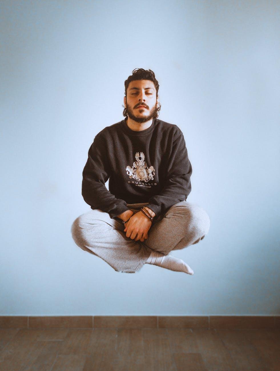 man in black long sleeves and gray sweatpants floating illustrating virtual reality