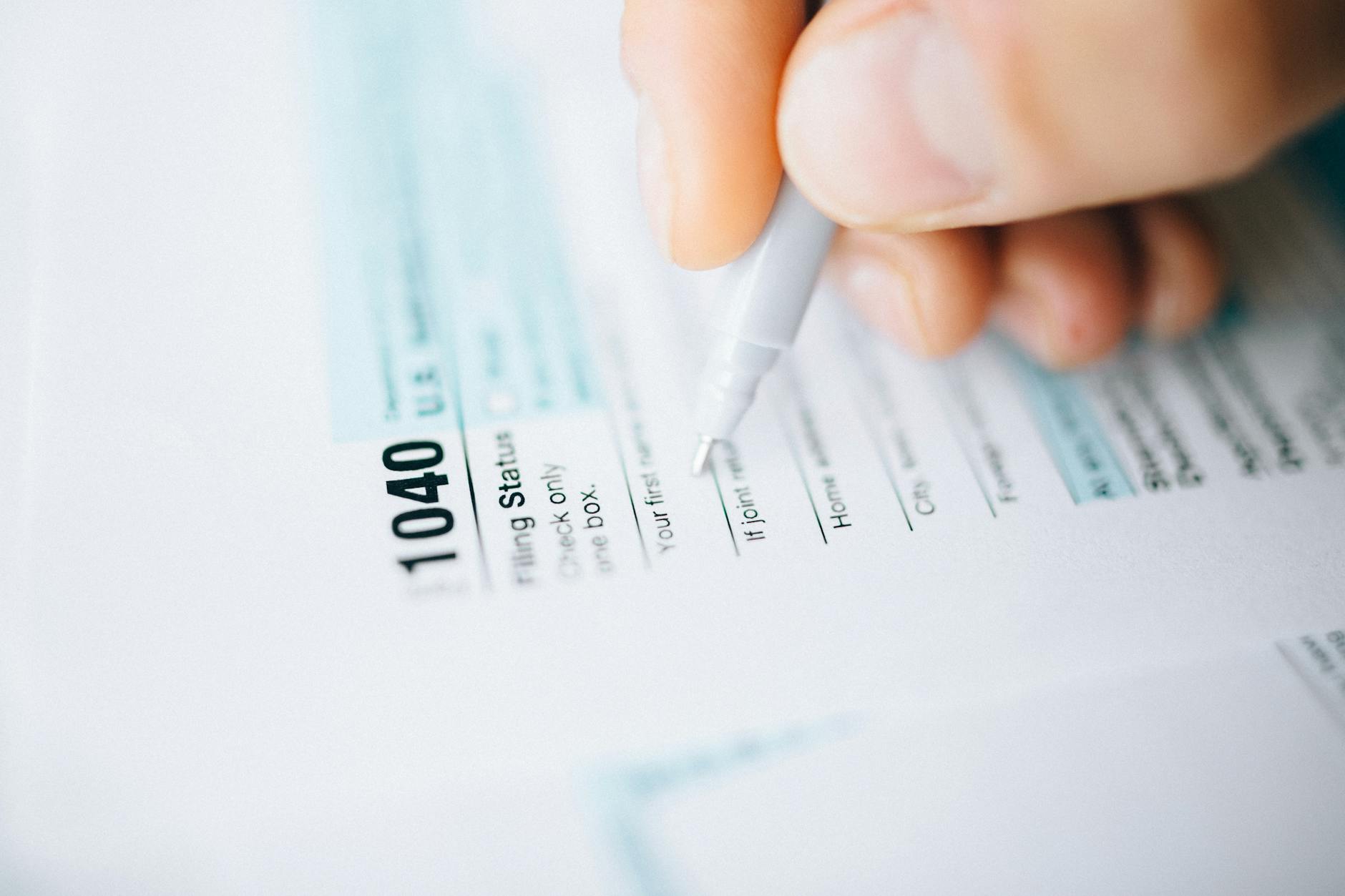 person filing tax documents. Taxes providing many expensive mental blocks.